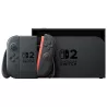 La console Nintendo Switch 2 insérée dans sa station d'accueil noire (dock TV) à côté du support pour manettes Joy-Con