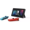 Console Nintendo Switch en mode sur table avec les manettes Joy Con bleu et rouge detachees